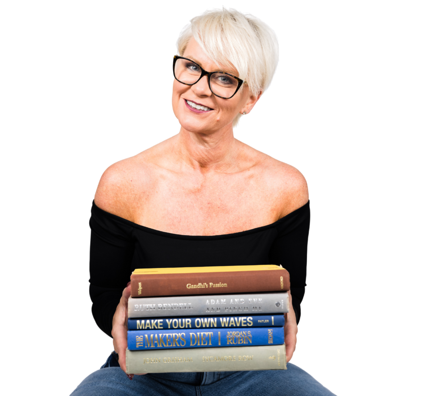 A woman with glasses holding a stack of books.